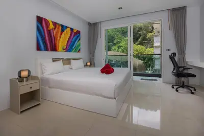a bedroom with a white bed and a large window at 1Br Horizon Suite at Patong - Emerald Hill 421 in Patong Beach