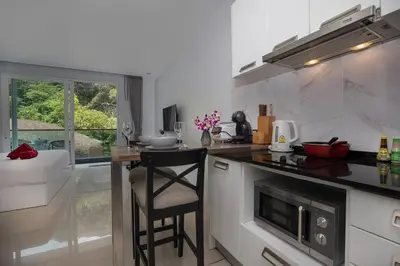 a kitchen with a counter with a stool in it at 1Br Horizon Suite at Patong - Emerald Hill 421 in Patong Beach