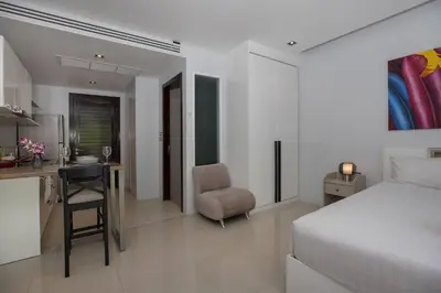 a bedroom with a bed and a desk and a chair at 1Br Horizon Suite at Patong - Emerald Hill 421 in Patong Beach