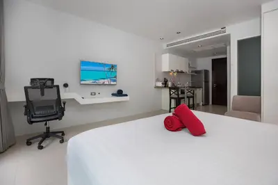 a bedroom with a bed with a red pillow on it at 1Br Horizon Suite at Patong - Emerald Hill 421 in Patong Beach