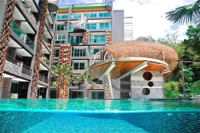 a swimming pool with a house in front of a building at 1Br Horizon Suite at Patong - Emerald Hill 421 in Patong Beach