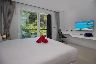 a bedroom with a bed with a red bow tie on it at 1Br Horizon Suite at Patong - Emerald Hill 421 in Patong Beach