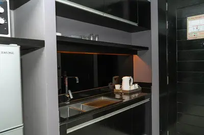 a kitchen with a sink and a counter top at Beachfront Deluxe BR Infinity Pool Patong Phuket in Patong Beach