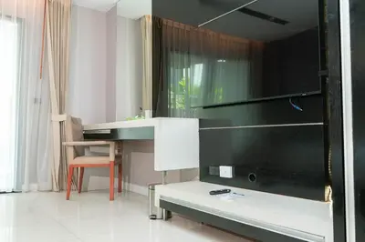 a bathroom with a sink and a mirror at Beachfront Deluxe BR Infinity Pool Patong Phuket in Patong Beach