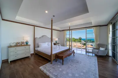 a bedroom with a canopy bed and a living room at Villa Seadream -Kata SeaView Villa-5 Mins to Beach best location in Phuket Town