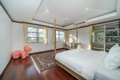 a bedroom with a bed and two windows at Villa Seadream -Kata SeaView Villa-5 Mins to Beach best location in Phuket Town