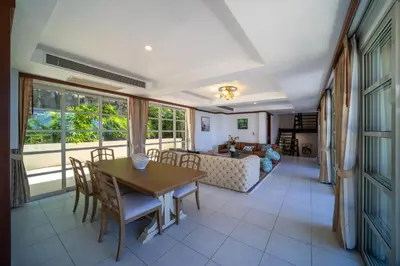 a living room with a table and chairs and a couch at Villa Seadream -Kata SeaView Villa-5 Mins to Beach best location in Phuket Town