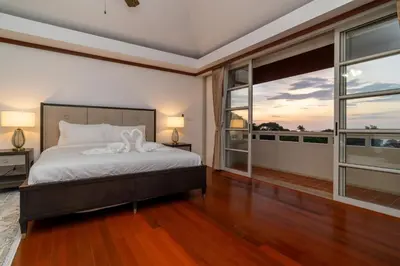 a bedroom with a bed and a large window at Villa Seadream -Kata SeaView Villa-5 Mins to Beach best location in Phuket Town