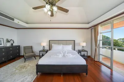a bedroom with a bed and a ceiling fan at Villa Seadream -Kata SeaView Villa-5 Mins to Beach best location in Phuket Town