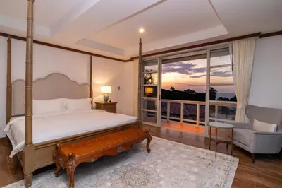 a bedroom with a bed and a large window at Villa Seadream -Kata SeaView Villa-5 Mins to Beach best location in Phuket Town