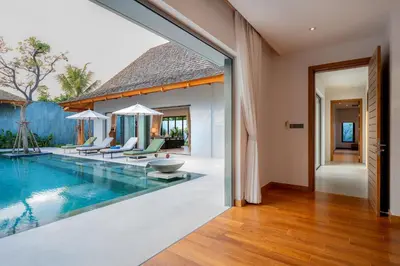an open living room with a swimming pool and a house at Anchan Bangtao 4 Bedroom Pool Luxury Courtyard Villa in Phuket