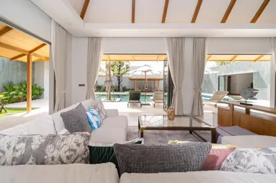 a living room with a couch and a table at Anchan Bangtao 4 Bedroom Pool Luxury Courtyard Villa in Phuket