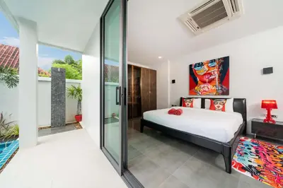 a bedroom with a bed and a glass wall at Unique Style & Comfort, 2BR Pool Villa DannyLys, near Nai Harn in Rawai Beach