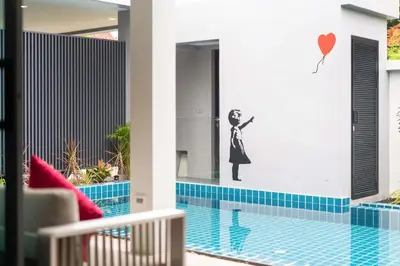 a house with a swimming pool with a sticker on the wall at Unique Style & Comfort, 2BR Pool Villa DannyLys, near Nai Harn in Rawai Beach