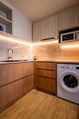 a kitchen with a washer and a washing machine at Cozy 1 BR beachfront apartment in Bang Tao Beach