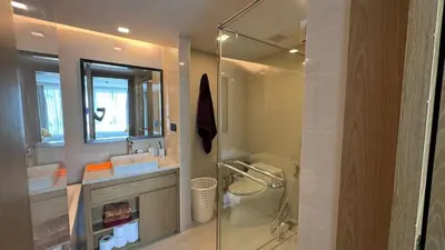 a bathroom with a shower and a sink and a mirror at La Vita Rawai 1 Bdr Roof Pool in Rawai Beach