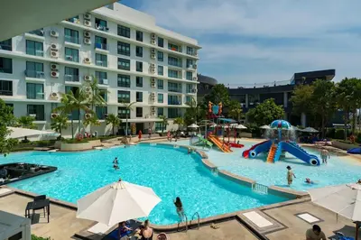 a pool at a hotel with people playing in it at La Vita Rawai 1 Bdr Roof Pool in Rawai Beach