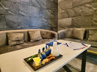 a table with a tray of food on a couch at La Vita Rawai 1 Bdr Roof Pool in Rawai Beach