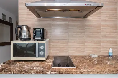 a microwave sitting on top of a counter in a kitchen at C206 Sea-View Condo 5 Min Walk to Kata Beach in Karon Beach