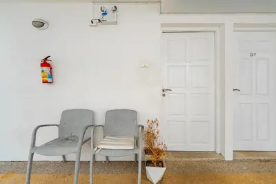 two chairs sitting in a room with a door at C206 Sea-View Condo 5 Min Walk to Kata Beach in Karon Beach