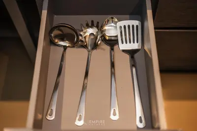 a group of silver utensils in a box at CityGate Kamala 1BR 3 min Beach in Kamala Beach