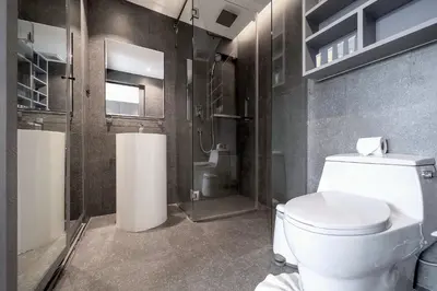a bathroom with a white toilet and a shower at Tropical & Modern Living - Hill View Tropics Kamala Suite CTG L707, Top Amenities & Beach Fun in Kamala Beach