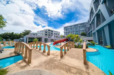 a swimming pool with a slide in a resort at \u6f9c\u8fd1 \u7af9\u9690\u5885 Nai Han Waves Edge Retreat in Rawai Beach