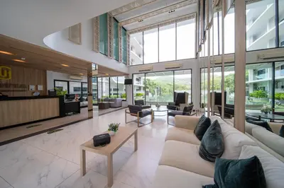a lobby with couches and chairs in a building at \u6f9c\u8fd1 \u7af9\u9690\u5885 Nai Han Waves Edge Retreat in Rawai Beach