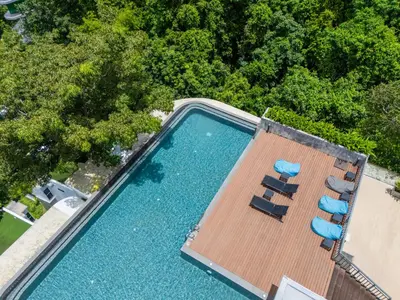 an overhead view of a swimming pool with two lounge chairs at \u6f9c\u8fd1 \u7af9\u9690\u5885 Nai Han Waves Edge Retreat in Rawai Beach