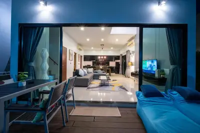 a living room with a couch and a tv at \u6f9c\u8fd1 \u7af9\u9690\u5885 Nai Han Waves Edge Retreat in Rawai Beach