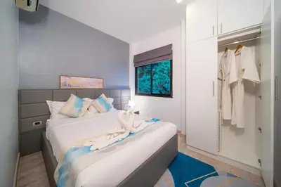 a bedroom with two beds and a closet at \u6f9c\u8fd1 \u7af9\u9690\u5885 Nai Han Waves Edge Retreat in Rawai Beach