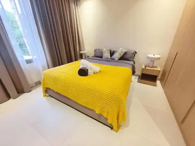 a bedroom with a bed with a yellow blanket at \u7af9\u5149\u522b\u9662 Bamboo Radiance Villa in Ban Thalat Choeng Thale