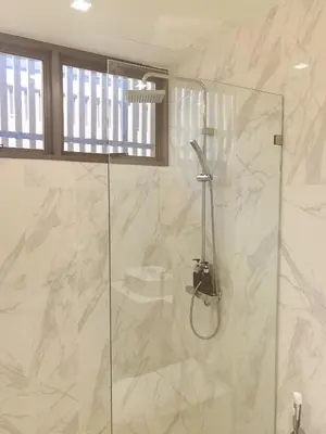 a bathroom with a shower with a glass door at \u7af9\u5149\u522b\u9662 Bamboo Radiance Villa in Ban Thalat Choeng Thale