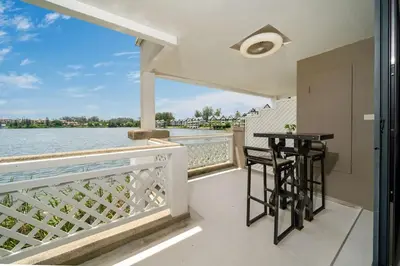 a balcony with a table and two stools at Beautiful 2BR Lakeview Apartment in Laguna in Laguna Phuket