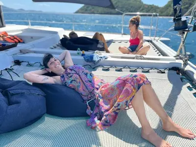 a woman laying on the back of a boat at Catamaran Lagoon 440 Calypso in Ban Bang Chak