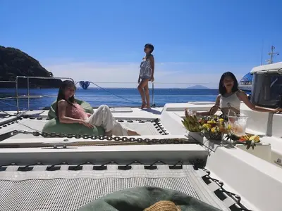 a group of women sitting on the back of a boat at Catamaran Lagoon 440 Calypso in Ban Bang Chak