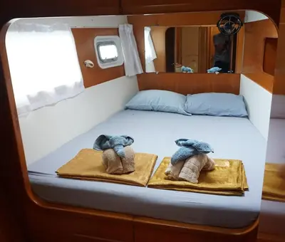 a bed in the middle of a boat with slippers at Catamaran Lagoon 440 Calypso in Ban Bang Chak