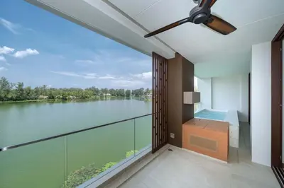 a large balcony with a view of a lake at Angsana Oceanview Residence Luxurious 2BR Lakeview Apartment in Laguna Phuket