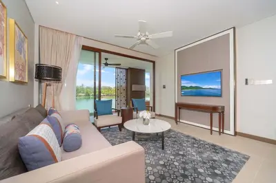 a living room with a couch and a table at Angsana Oceanview Residence Luxurious 2BR Lakeview Apartment in Laguna Phuket