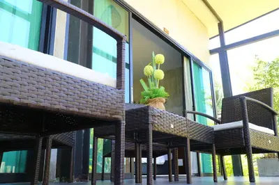 a potted plant sitting on a table in front of a building at Baan Norkna Bangtao in Bang Tao Beach
