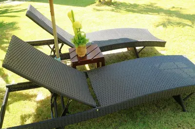two benches and a table with a plant on it at Baan Norkna Bangtao in Bang Tao Beach