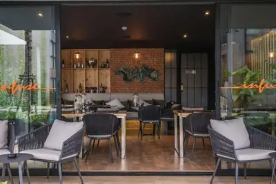 a restaurant with chairs and tables in a room at Diamond Condominium 1 BR Bangtao beach in Bang Tao Beach