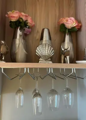 a shelf with wine glasses and flowers on it at Diamond Condominium 1 BR Bangtao beach in Bang Tao Beach