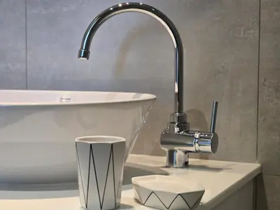 a bathroom sink with a faucet and a bowl at Endless white 2BR apartment-300m to NaiYang Beach in Nai Yang Beach