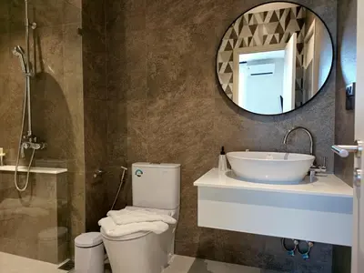 a bathroom with a toilet and a sink and a mirror at Endless white 2BR apartment-300m to NaiYang Beach in Nai Yang Beach