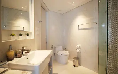 a bathroom with a sink and a toilet and a shower at Cassia Lakeview 1BR Apartments, 10min to Beach in Laguna Phuket