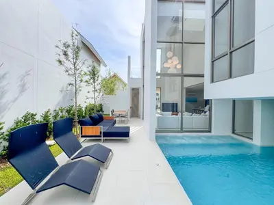 a house with a swimming pool and blue chairs at Luxpride 3BR near laguna friendly villa with Garden&pool in Ban Pak Lak