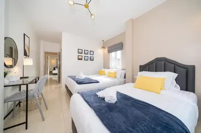 a hotel room with two beds and a desk at 6BDR patong pool villa by Mp property in Patong Beach