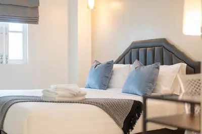 a bedroom with a bed with blue and white pillows at 6BDR patong pool villa by Mp property in Patong Beach