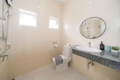 a bathroom with a toilet and a sink and a mirror at 6BDR patong pool villa by Mp property in Patong Beach